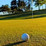 green grass with the flag in the hole.