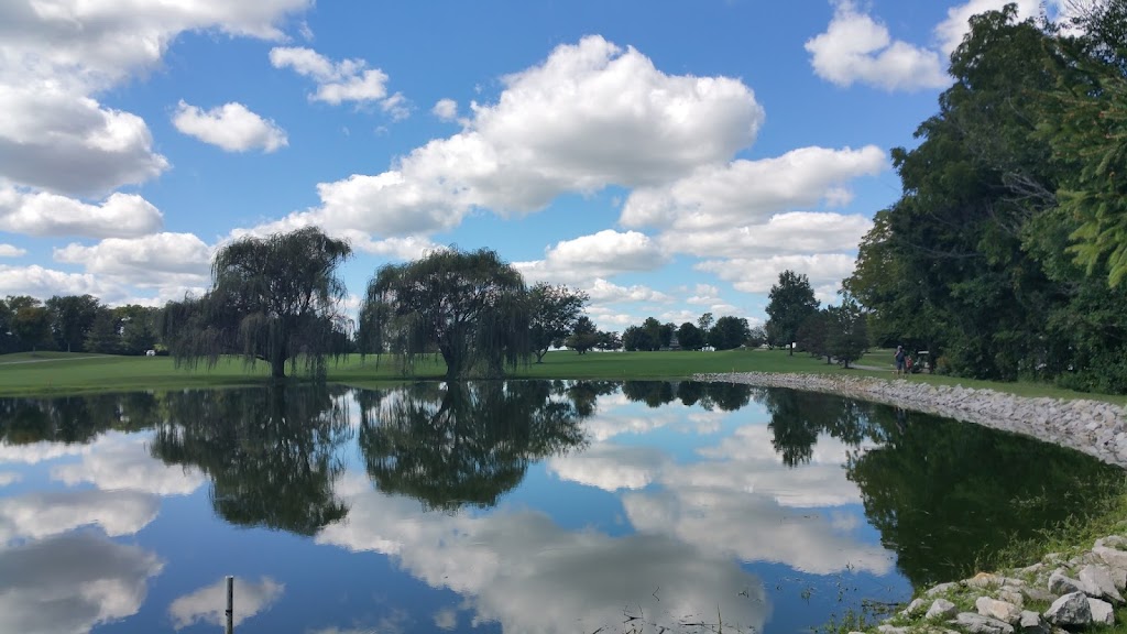 Panoramic view of a lush green golf course at Deer Creek Golf Club. Smooth