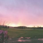 Panoramic view of a lush green golf course at Deer Lodge Golf Course (aka Deer Park Golf Course). Smooth
