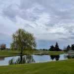 Panoramic view of a lush green golf course at Deer Park Golf Club. Smooth