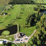 Panoramic view of a lush green golf course at Deer Track Golf Club. Smooth