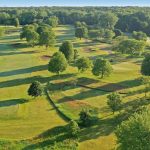 Panoramic view of a lush green golf course at Deerpath Golf Course. Smooth