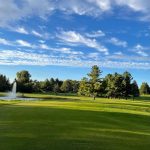 Panoramic view of a lush green golf course at Deertrak Golf Club. Smooth