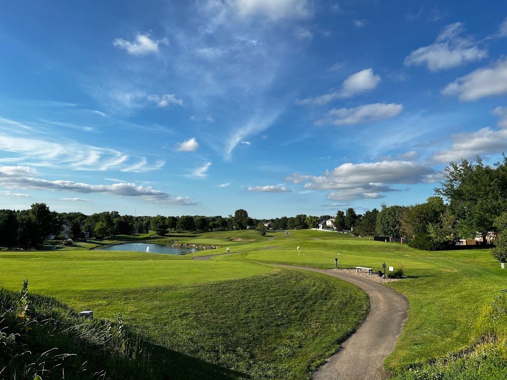 Panoramic view of a lush green golf course at Den at Fox Creek. Smooth