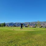 Panoramic view of a lush green golf course at Desert Aire Golf Club. Smooth