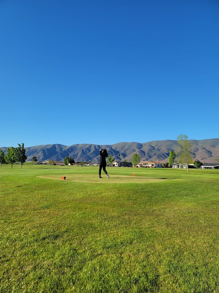 Panoramic view of a lush green golf course at Desert Aire Golf Club. Smooth
