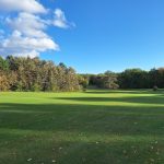 Panoramic view of a lush green golf course at Devil's Knob Golf Course. Smooth