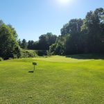 Panoramic view of a lush green golf course at Diamond Springs Golf Course. Smooth