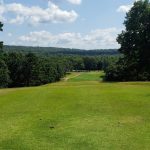 Panoramic view of a lush green golf course at Diamondhead Golf Club. Smooth