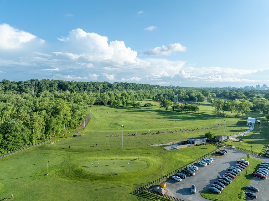 Panoramic view of a lush green golf course at Different Strokes Golf Center. Smooth