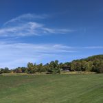 Panoramic view of a lush green golf course at Dinsmore Golf Course. Smooth