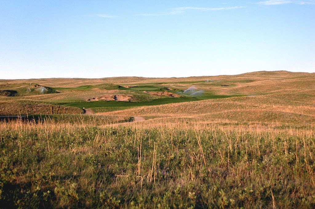 Panoramic view of a lush green golf course at Dismal River. Smooth