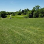 Panoramic view of a lush green golf course at Dix River Golf Course. Smooth
