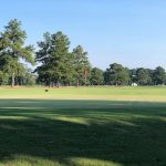 Panoramic view of a lush green golf course at Dixie Golf Association. Smooth