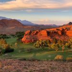 Panoramic view of a lush green golf course at Dixie Red Hills Golf Course. Smooth