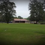 Panoramic view of a lush green golf course at Dogwood Hills Golf Course. Smooth
