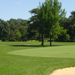 Panoramic view of a lush green golf course at Donald Ross Golf Club. Smooth