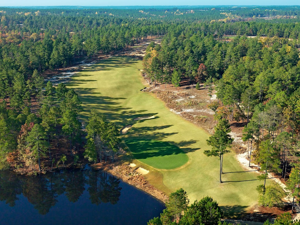 Panoramic view of a lush green golf course at Dormie Club. Smooth