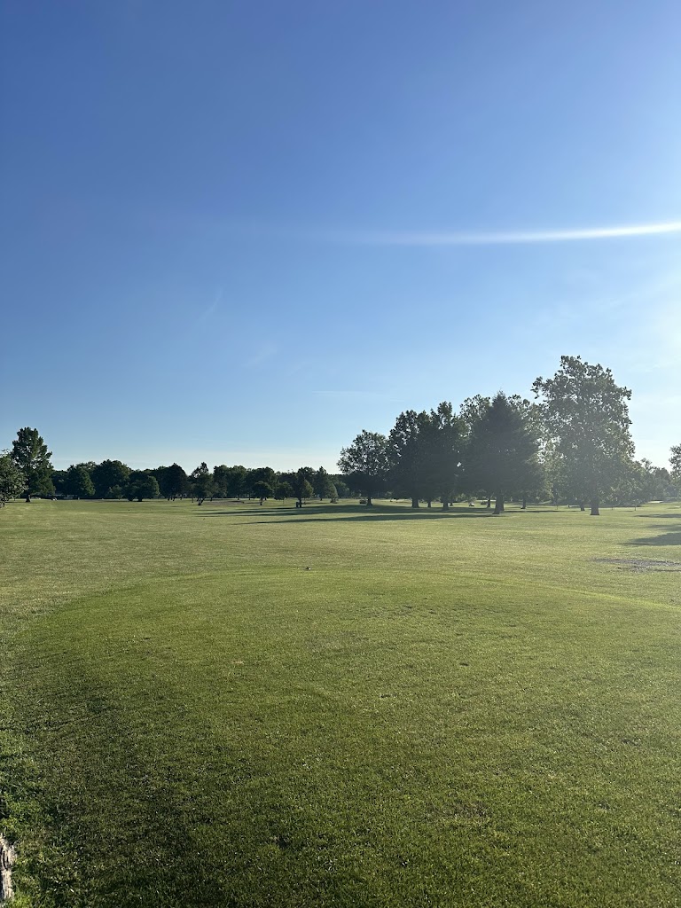 Panoramic view of a lush green golf course at Douglass Golf Course. Smooth