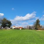 Panoramic view of a lush green golf course at Douglaston Golf Course. Smooth