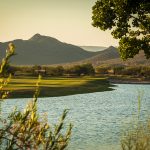 Panoramic view of a lush green golf course at Dove Valley Ranch Golf Club. Smooth