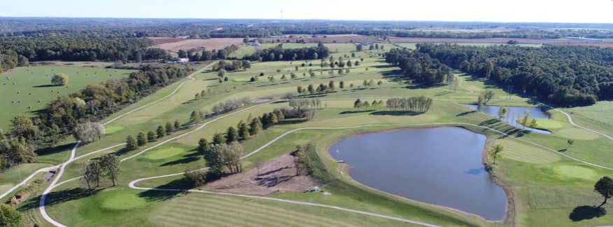 Panoramic view of a lush green golf course at Dream Valley Golf Course. Smooth
