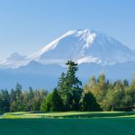 Panoramic view of a lush green golf course at Druid's Glen Golf Club. Smooth