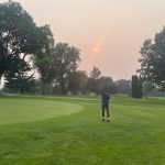 Panoramic view of a lush green golf course at Duck Creek Golf Course. Smooth