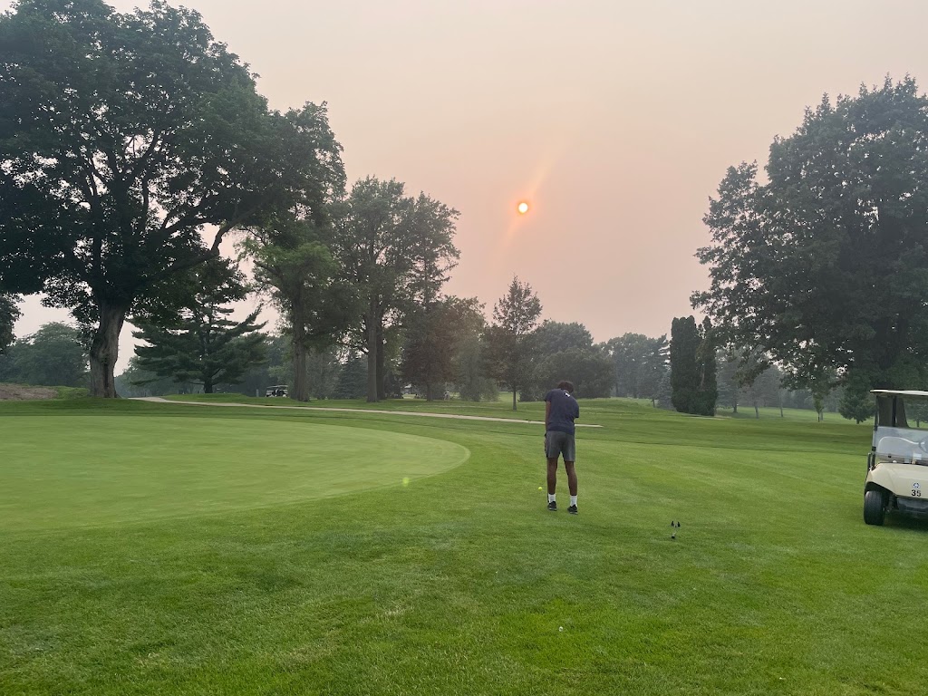 Panoramic view of a lush green golf course at Duck Creek Golf Course. Smooth