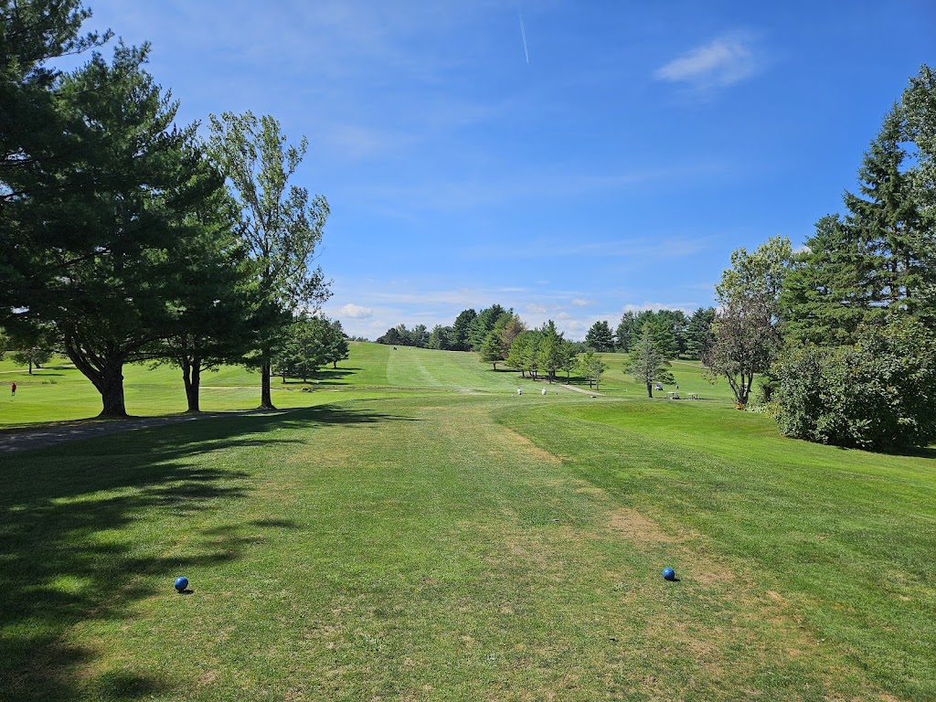 Panoramic view of a lush green golf course at Dutch Elm Golf Course. Smooth