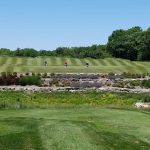Panoramic view of a lush green golf course at Eagle Bend Golf Course. Smooth