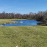 Panoramic view of a lush green golf course at Eagle Creek Golf Club. Smooth