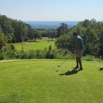 Panoramic view of a lush green golf course at Eagle Crest Golf Course. Smooth