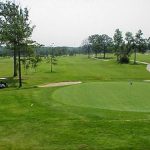 Panoramic view of a lush green golf course at Eagle Hill Golf Course. Smooth