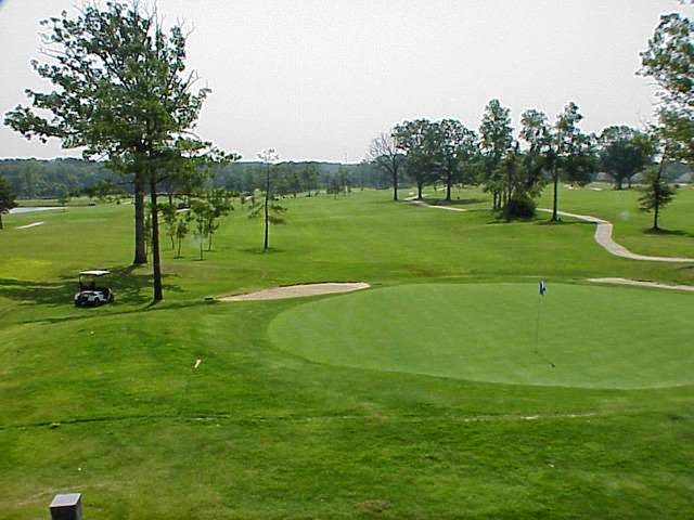 Panoramic view of a lush green golf course at Eagle Hill Golf Course. Smooth
