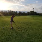 green grass with the flag in the hole.