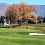Panoramic view of a lush green golf course at Eagle Lake Golf Course. Smooth