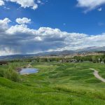 Panoramic view of a lush green golf course at Eagle Ranch Golf Course. Smooth