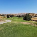 Panoramic view of a lush green golf course at Eagle Springs Golf & Country Club. Smooth
