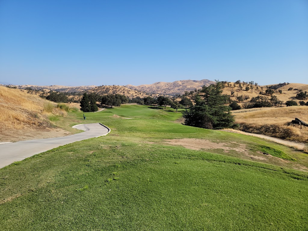 Panoramic view of a lush green golf course at Eagle Springs Golf & Country Club. Smooth