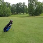 green grass with the flag in the hole.