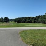 Panoramic view of a lush green golf course at Eagle Trace Golf Course. Smooth