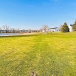 Panoramic view of a lush green golf course at Eagle Valley Golf Course. Smooth