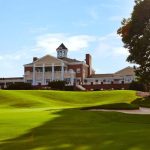 Panoramic view of a lush green golf course at Eagles Landing Country Club. Smooth