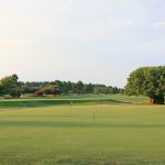 Panoramic view of a lush green golf course at Eagle's Landing Golf Course. Smooth