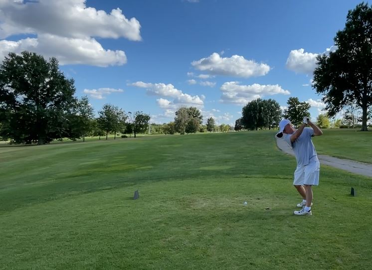 Panoramic view of a lush green golf course at Eagles' Landing Golf Course. Smooth