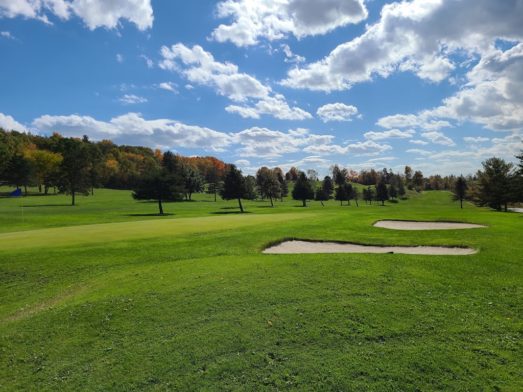 Panoramic view of a lush green golf course at Eagles Ridge Golf Course. Smooth