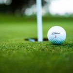 green grass with the flag in the hole.