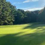 Panoramic view of a lush green golf course at East Greenwich Country Club. Smooth