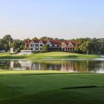 Panoramic view of a lush green golf course at East Lake Golf Club. Smooth